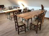 many chairs and tables in a room with a skylight