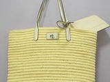 a close up of a yellow handbag hanging on a hook