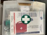 a first aid kit in a plastic box on a table