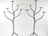 pair of black iron candelabs with candlesticks in the shape of trees