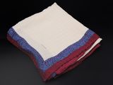 a close up of two folded towels on a black surface