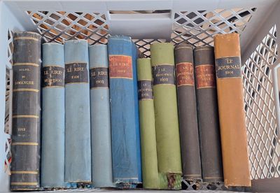 many old books in a white box on a shelf