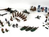 a lot of toy soldiers that are on a white surface