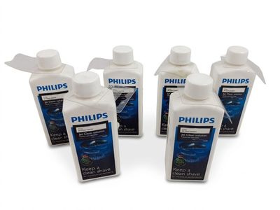 four bottles of philips ' s water are lined up on a white surface