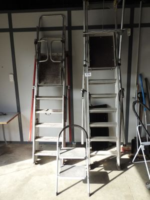 two ladders that are next to each other in a garage