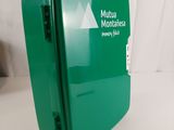 a green box with a sign on it on a table