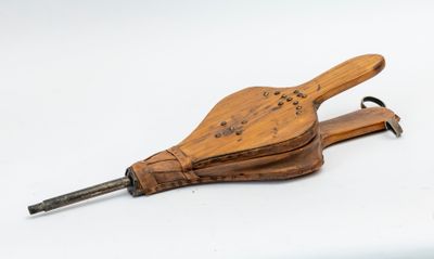 a wooden instrument that is sitting on a white surface