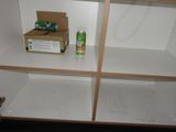 a box of soda and a can of soda sitting on a shelf
