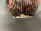 a close up of a vase on a table