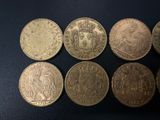 a group of five different coins sitting on top of a table