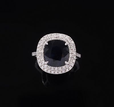 a black and white diamond ring on a black background