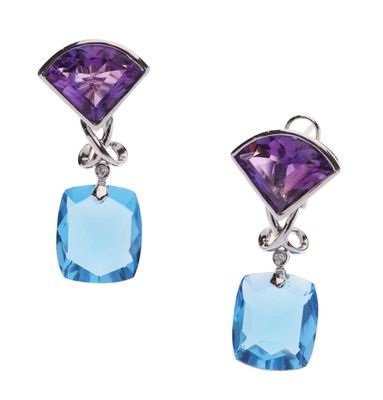 a pair of earrings with blue and purple stones