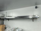 many plates and cups on the shelf in the kitchen