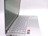 a silver laptop computer sitting on top of a white table