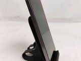 a cell phone that is on a stand on a table