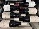 several bottles of wine are lined up on a rack in a wine cellar