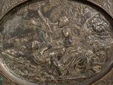 a silver plate with a picture of a man and a woman on it