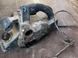an image of a corded sander sitting on top of a table