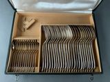 a lot of silverware in a box on the table
