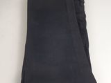 the black pants are folded up on a white surface
