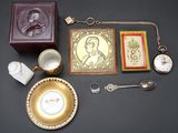 a gold plate with a picture of a man on it next to other items