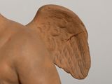 a statue of a man with wings on his head