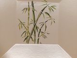 a picture of a plate with a painting of a bamboo tree on it