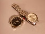 two watches sitting next to each other on a table
