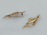 two gold plated brooches and a pair of scissors
