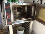 a toaster oven with a lot of bottles of milk on top of it