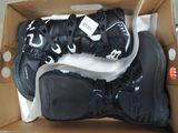 a box with a pair of black snow boots in it