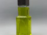 perfume bottle with green liquid on a white background