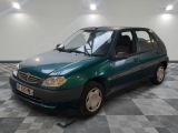 a picture of a small green car parked in a garage