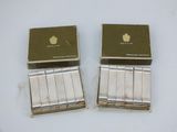 two boxes of cigarettes sitting next to each other on a table