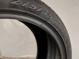 a close up of a tire on a white surface