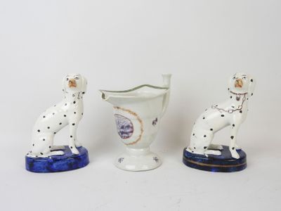 three porcelain figurines of dalmatian dogs and a vase