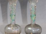 two glass vases that are sitting on a table