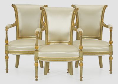 three chairs and a ottoman are sitting on a white surface