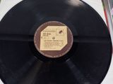 vinyl record with a label on it sitting on a table