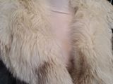 a mannequin wearing a fur coat on a mannequin stand