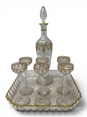 a tray with wine glasses and a decanter on it
