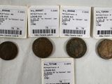four different types of coins are shown on a white surface