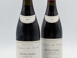 deux bouteilles de vin rouge posées l'une à côté de l'autre sur une surface blanche