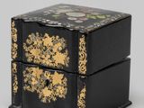 an image of a black and gold box sitting on top of a table