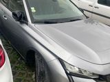 a silver car that is parked on the side of the road