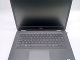 the dell laptop is open and ready to be used on the desk