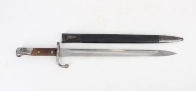 a knife that is laying on a white surface