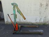 an old rusted metal hand truck with a hammer on it