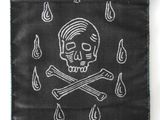 skull and crossbones embroidered on a black cloth bag