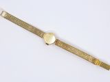 a close up of a watch on a white surface with a white background